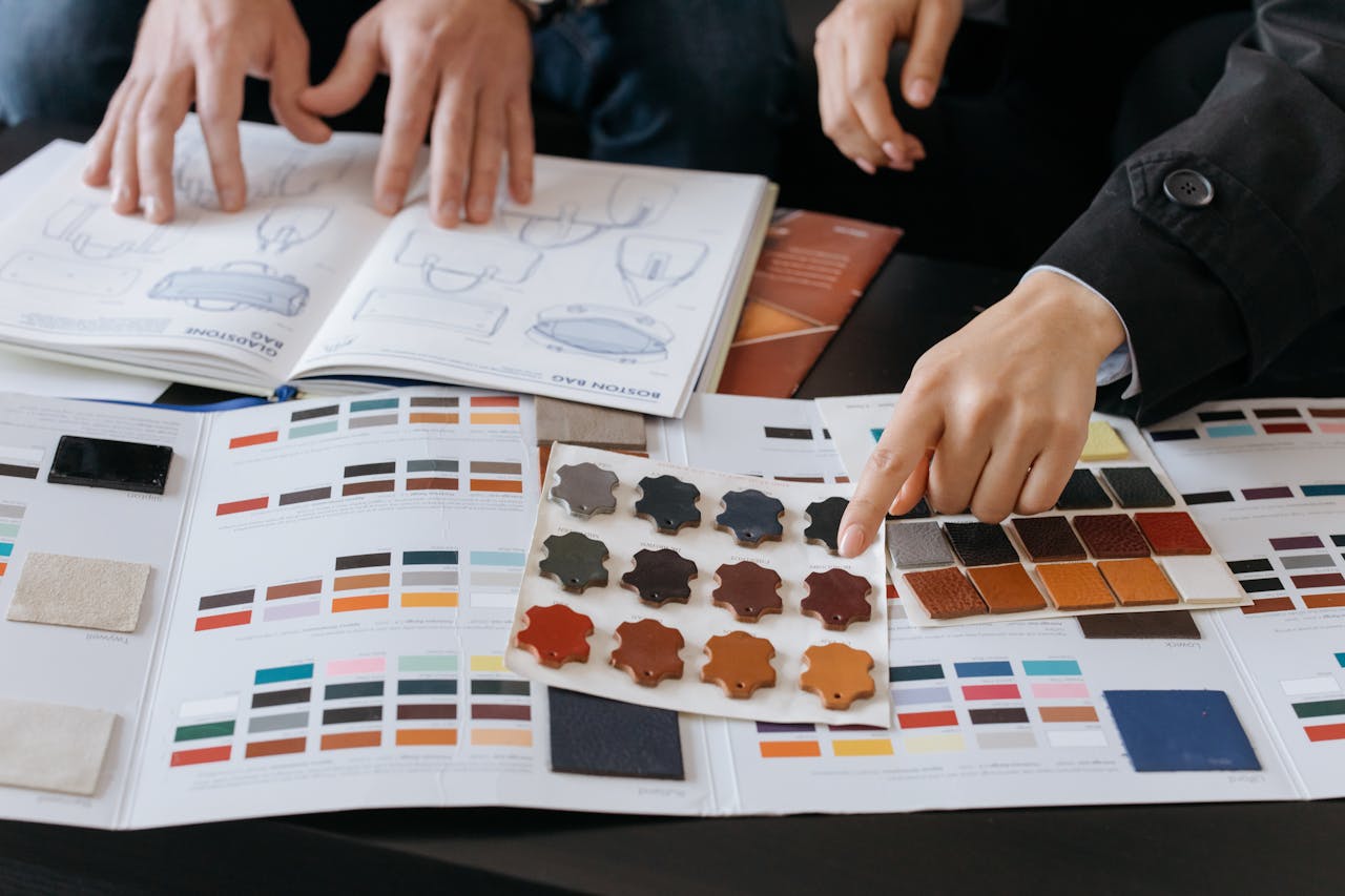 Designers reviewing color swatches and sketches for project planning.